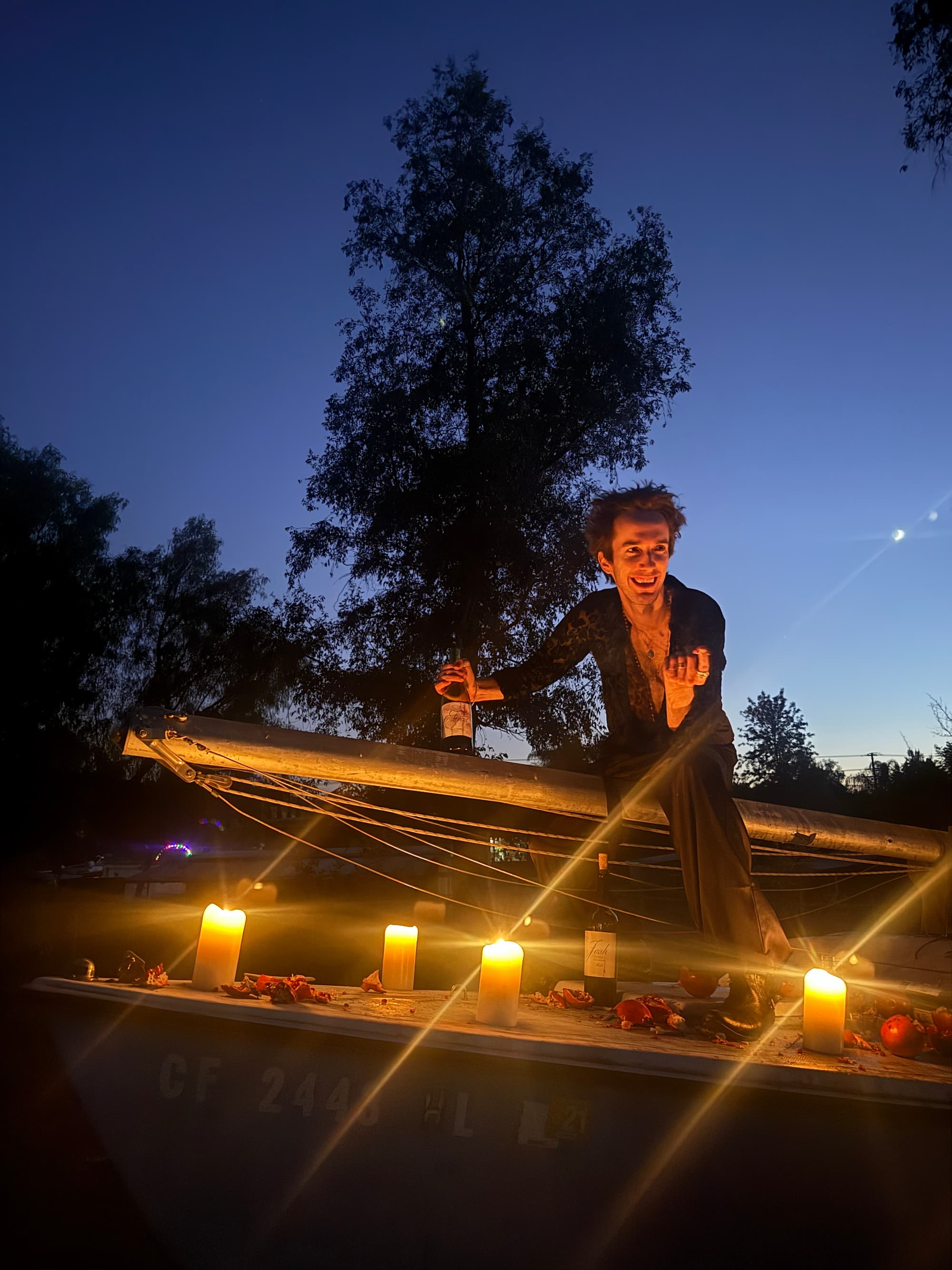 Actor on sailboat at night with candles